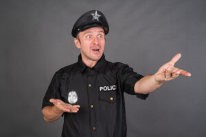 Frustrated Caucasian man wearing police uniform costume in studio